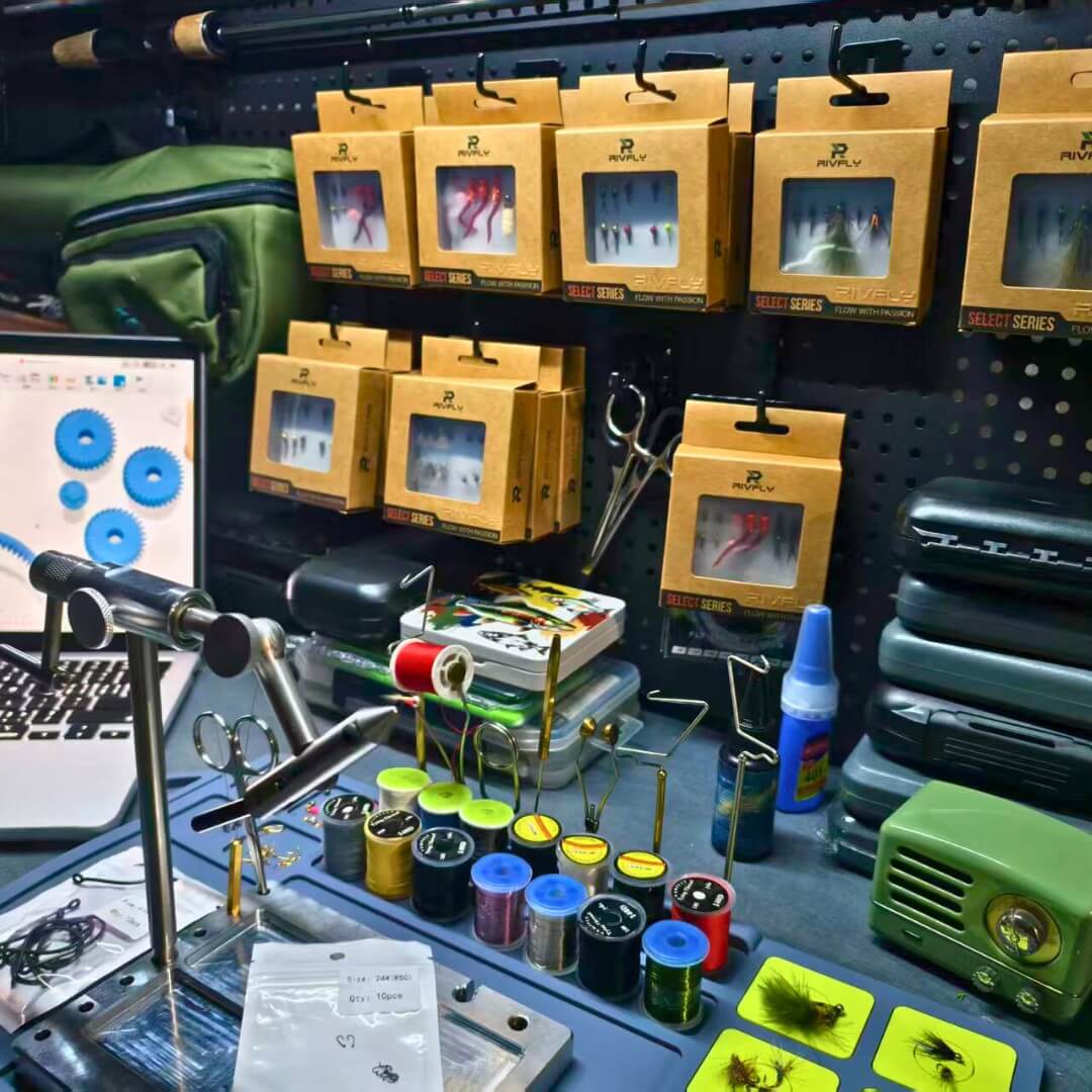 Rivfly founder engineering workbench with CAD designs and fly tying tools.